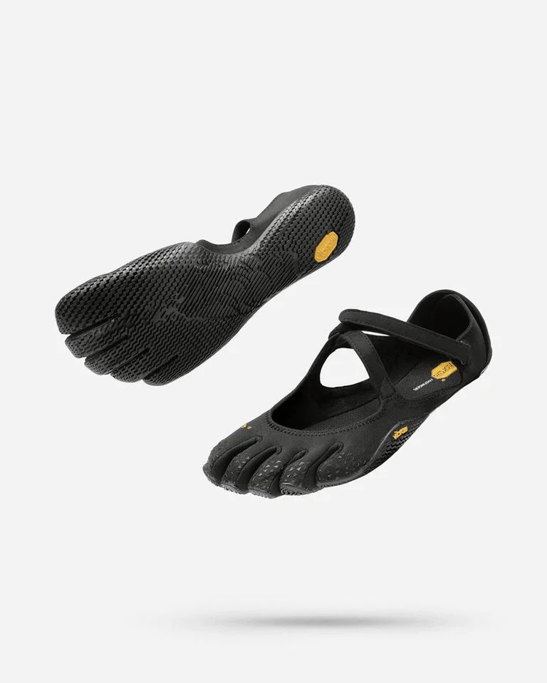 Two pairs of Vibram V-Soul (Women’s) black minimalist barefoot shoes, featuring separate toe sections, flexible soles, and a top strap—perfect for yoga or pilates—are shown floating against a white background.