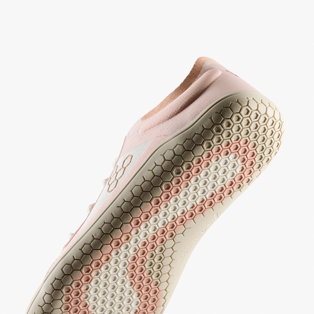 The VIVOBAREFOOT Primus Lite IV (Women's) is a light pink barefoot trainer with a honeycomb-patterned sole in pink and beige, shown from below against a white background—engineered for natural movement.