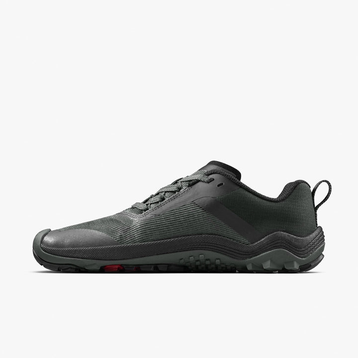 The VIVOBAREFOOT Primus Trail Flow (Women's) is a dark gray, lightweight, low-cut trail shoe with an all-terrain outsole and lace-up closure, shown in side view on a plain white background.
