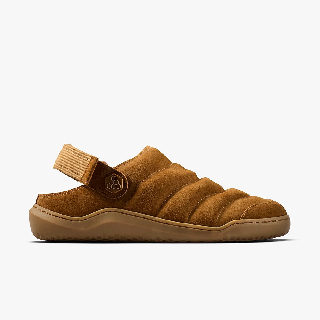 The Gobi Wavey Mule (Men's) is a brown quilted leather sandal with a cozy upper, adjustable back strap, and textured rubber sole, shown in profile against a plain white background.
