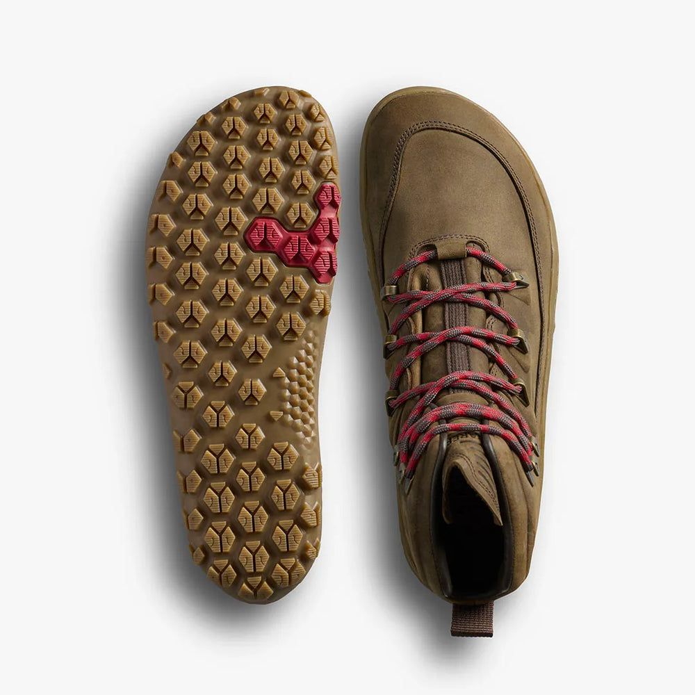 A pair of VIVOBAREFOOT Tracker Leather AT II (Men's) brown barefoot hiking boots shown from above and below; the left shoe reveals a textured sole with a red hexagonal pattern, while the right features water-resistant red-brown laces.