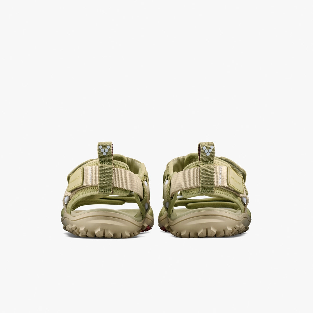 The VIVOBAREFOOT Tracker Ora Sandal (Women's) is shown from the back in light green and beige, featuring rugged soles, thick adjustable straps, and a durable neoprene upper for comfort—all against a white background.