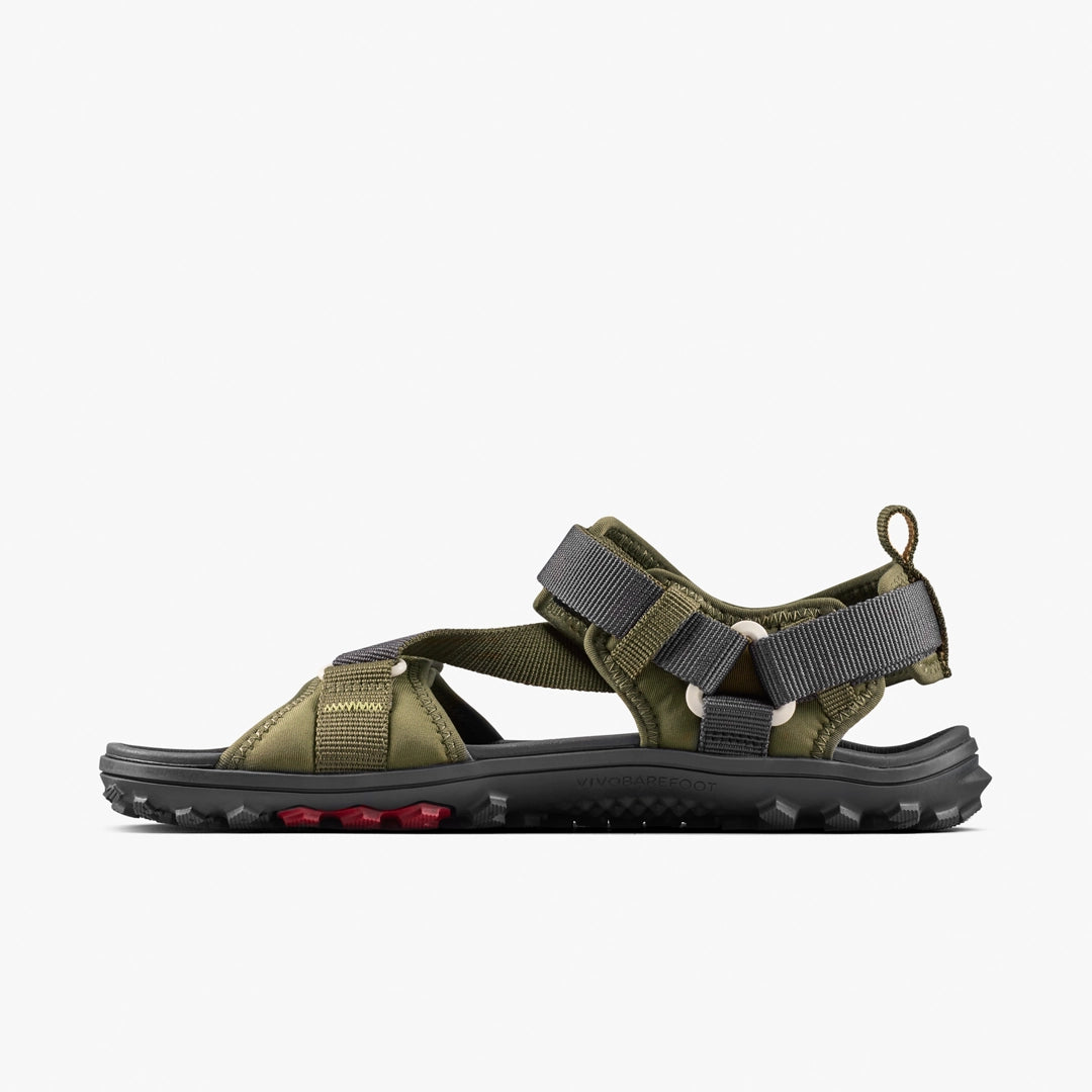 The VIVOBAREFOOT Tracker Ora Sandal (Women's) features olive green straps, grey adjustable buckles, and a black textured sole with red tread accents, shown against a plain white background.