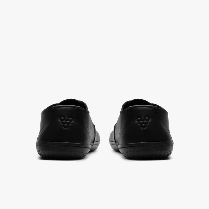 The VIVOBAREFOOT Ra IV (Men’s) sneakers, shown from the back against a white background, showcase supple Wild Hide leather and feature a small embossed dot pattern on each heel.