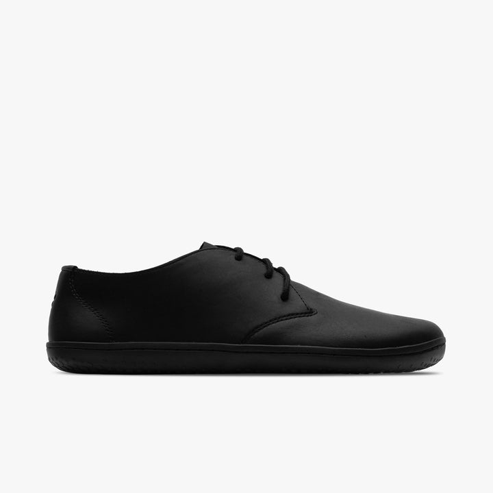 The VIVOBAREFOOT Ra IV (Men’s) is a minimalist black barefoot Oxford with a flexible Gobi outsole and smooth Wild Hide leather upper, shown in side view on a white background.
