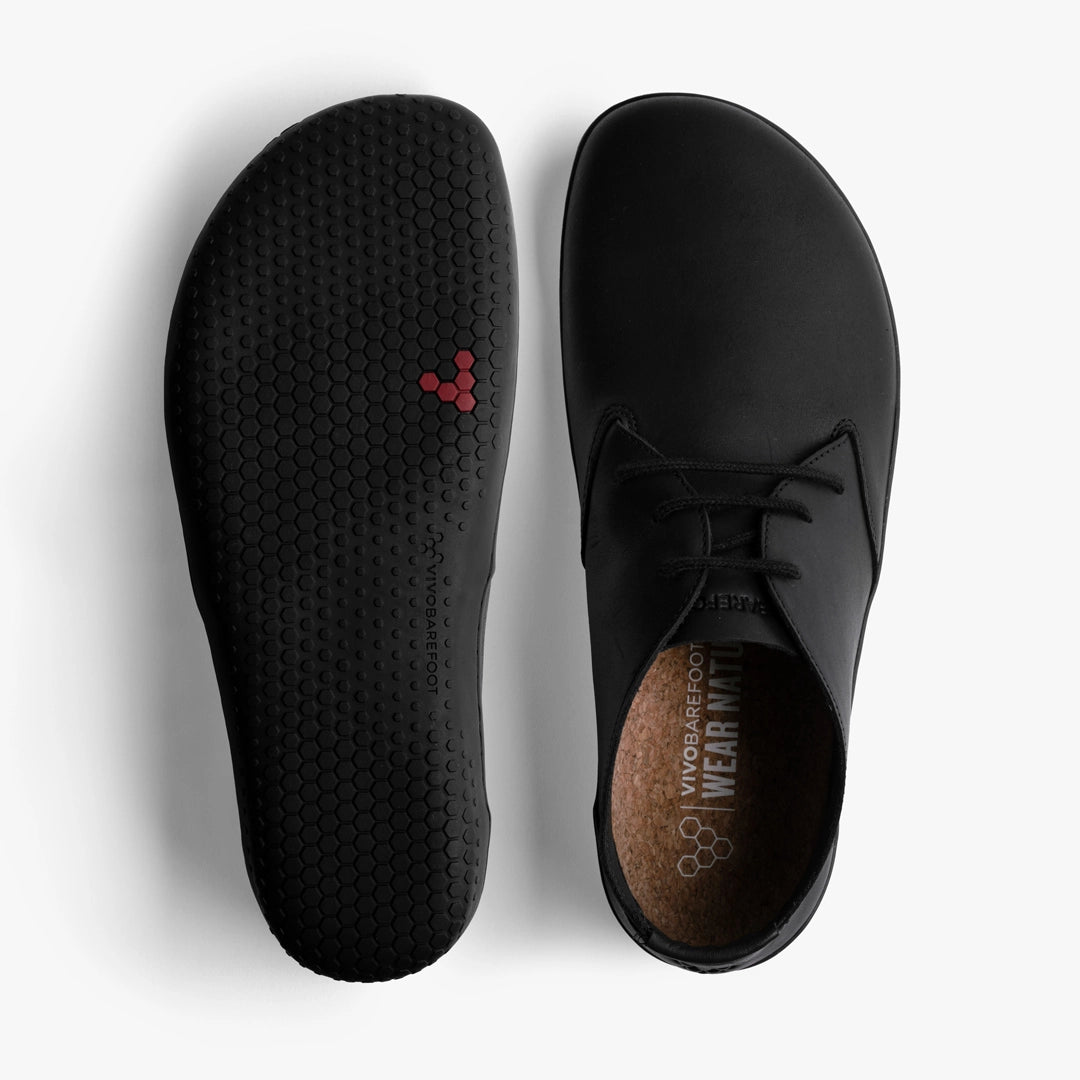 A pair of VIVOBAREFOOT Ra IV (Men's) black barefoot Oxford shoes shown from above and below. One displays the hexagonal Gobi outsole with a small red logo, and the other shows an insole labeled "Vivobarefoot Wear.