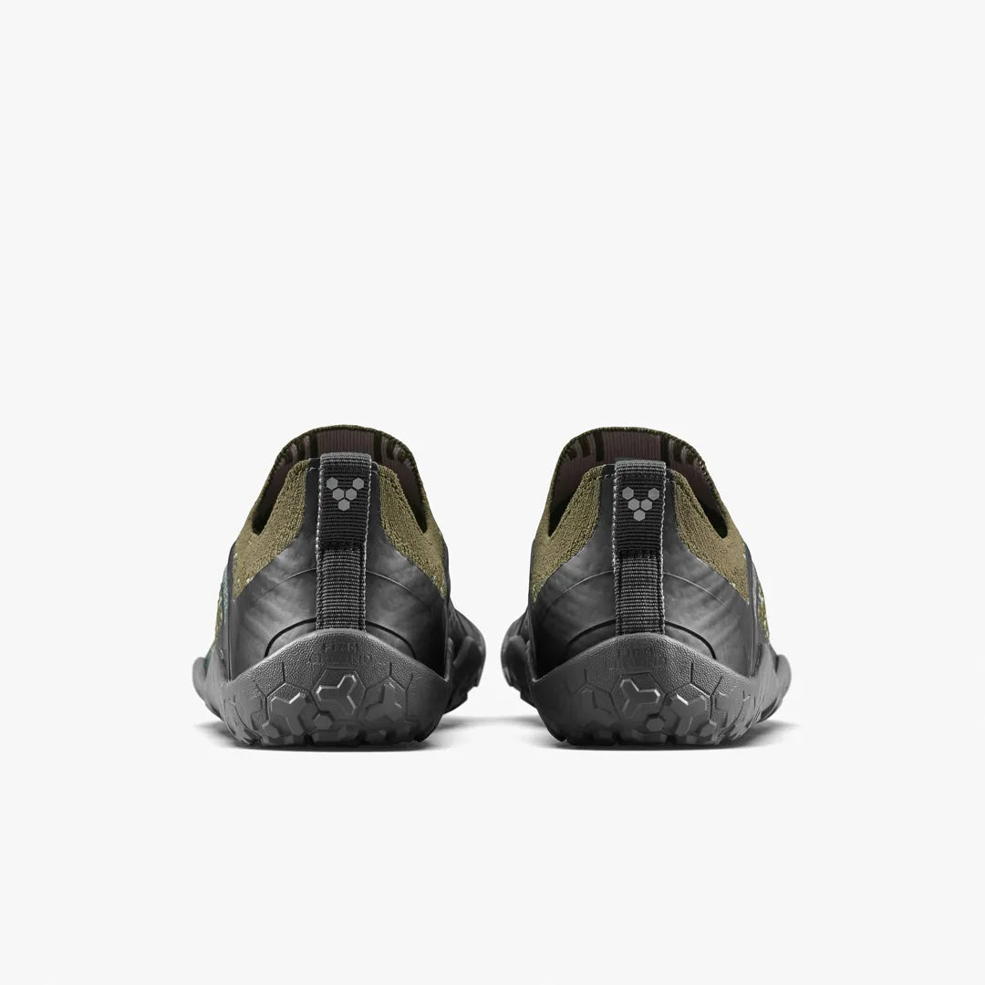 Back view of a pair of olive green and black VIVOBAREFOOT Primus Trail Knit FG Grounding (Men’s) barefoot trail shoes with textured firm ground soles.