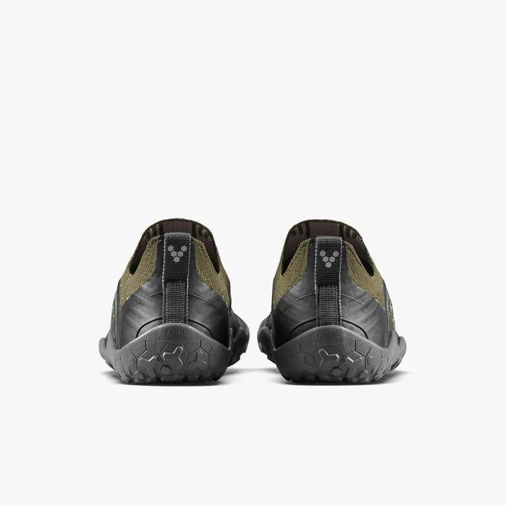 Back view of a pair of olive green and black VIVOBAREFOOT Primus Trail Knit FG Grounding (Men’s) barefoot trail shoes with textured firm ground soles.