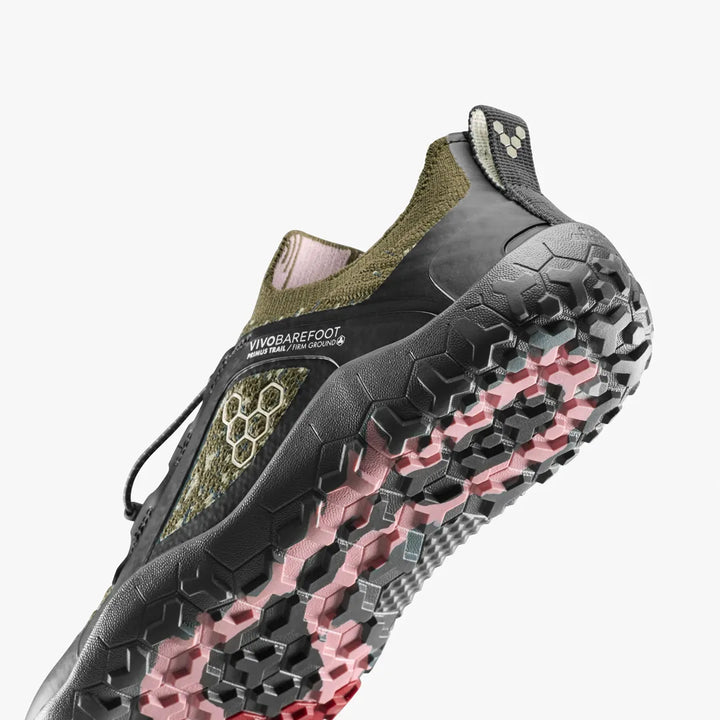 Close-up of the firm ground sole and heel of a VIVOBAREFOOT Primus Trail Knit FG Grounding (Men’s) shoe, showing the tread pattern and branding.