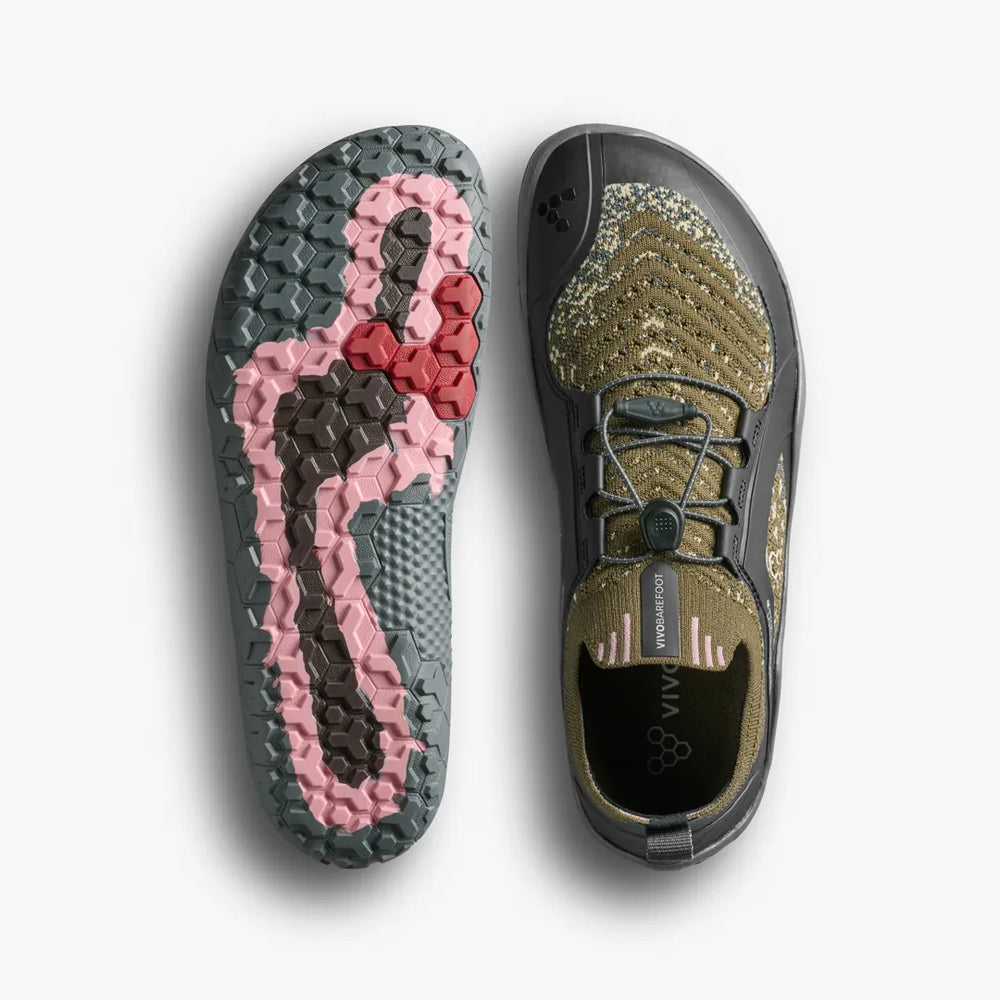 A pair of VIVOBAREFOOT Primus Trail Knit FG Grounding (Men’s) barefoot trail shoes shown from the top and the underside, featuring a multi-colored firm ground sole and a green knit upper with a toggle lace system.