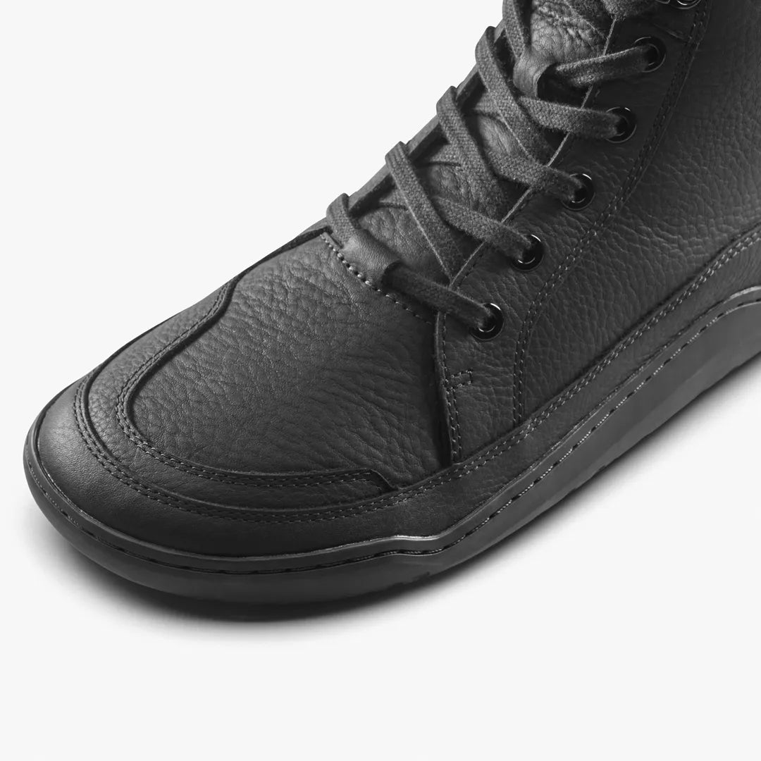 Close-up of a black Gobi Boot II Warmlined (Men’s) leather ankle boot with a textured upper and a flat, flexible sole.