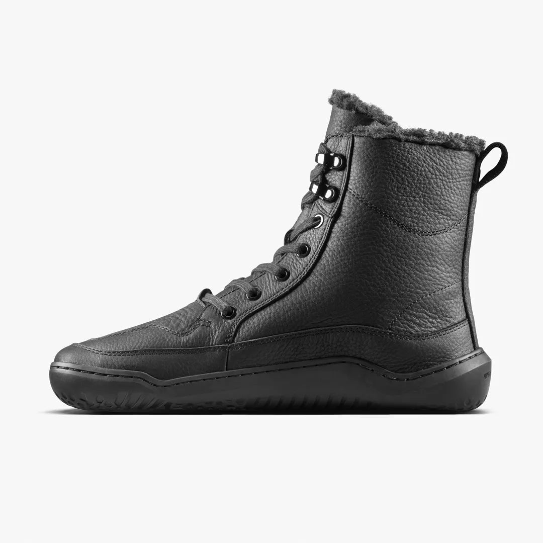 Black leather VIVOBAREFOOT Gobi Boot II Warmlined (Men’s) high-top lace-up boots with a thin, flat rubber sole and a warm-lined faux fur interior.