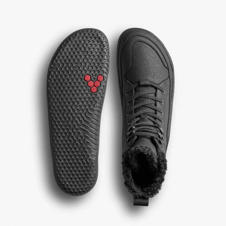 Top-down view of a black VIVOBAREFOOT Gobi Boot II Warmlined boot with a shearling lining next to its textured rubber outsole.