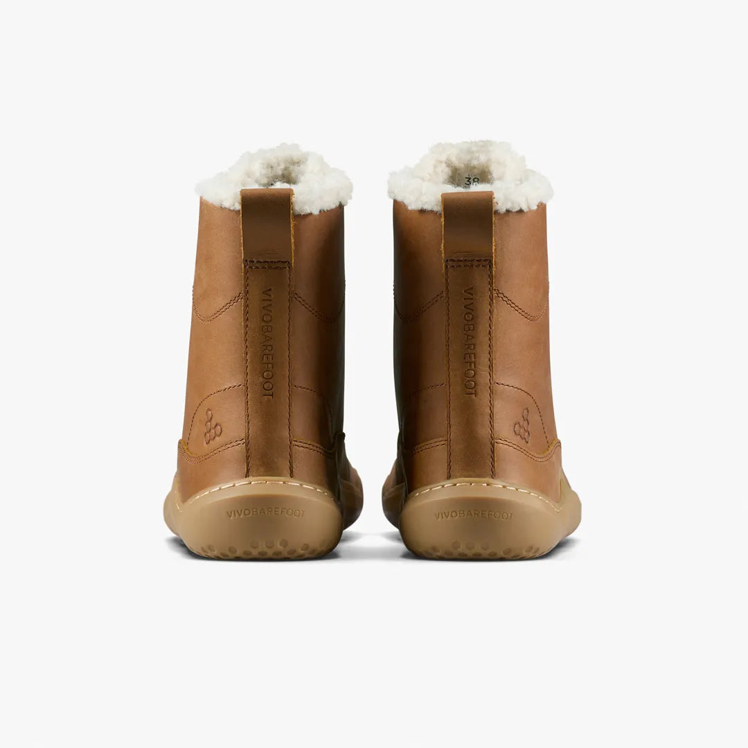 Rear view of two tan Wild Hide leather Gobi Boot II Warmlined (Women) ankle boots with faux shearling lining and flat rubber soles.