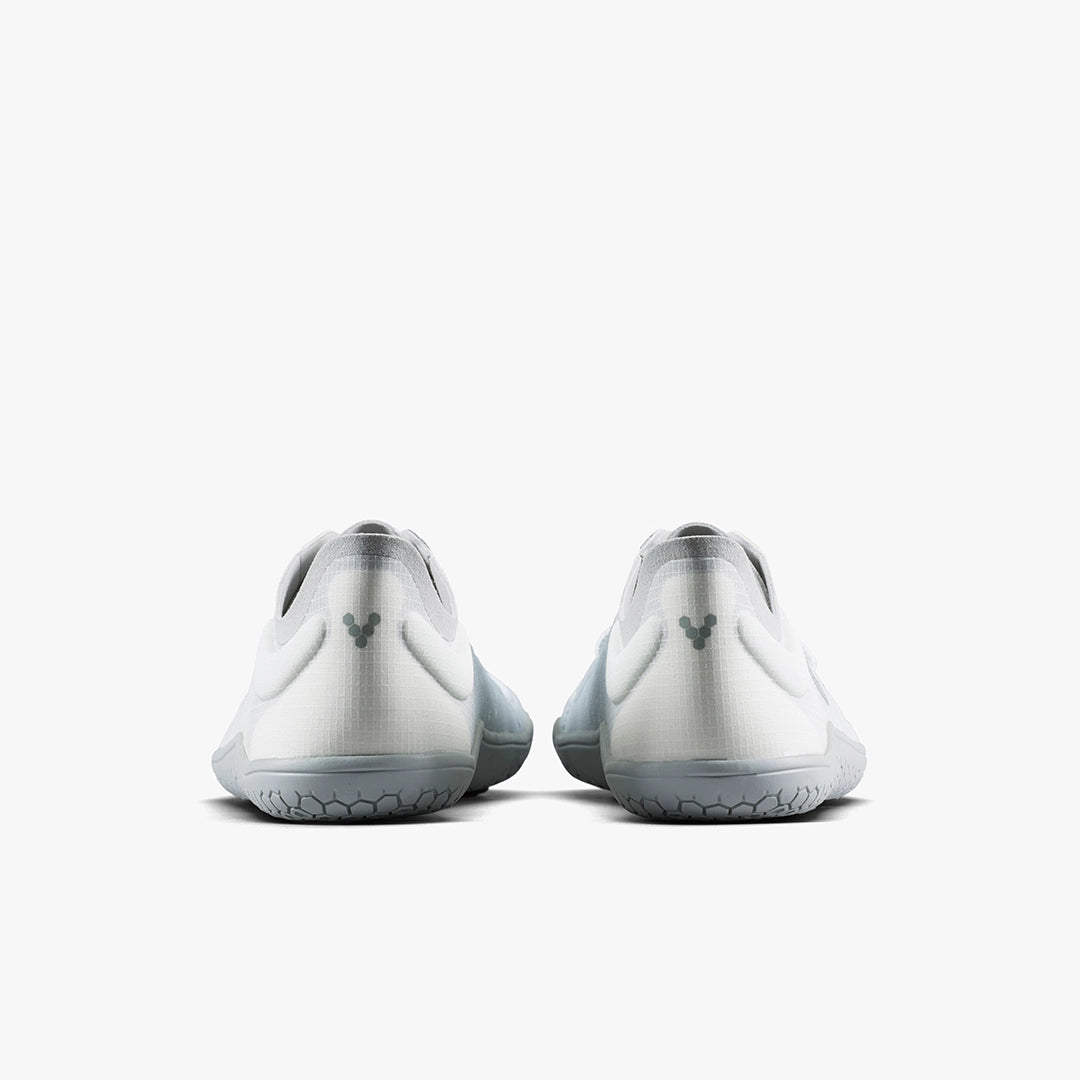 The VIVOBAREFOOT Primus Lite IV (Men's) are white and gray minimalist athletic shoes made with recycled materials, shown from the back with a small heel logo against a plain white background.