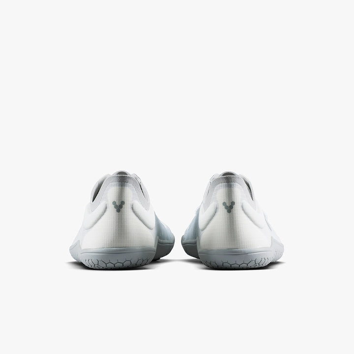 The VIVOBAREFOOT Primus Lite IV (Men's) are white and gray minimalist athletic shoes made with recycled materials, shown from the back with a small heel logo against a plain white background.