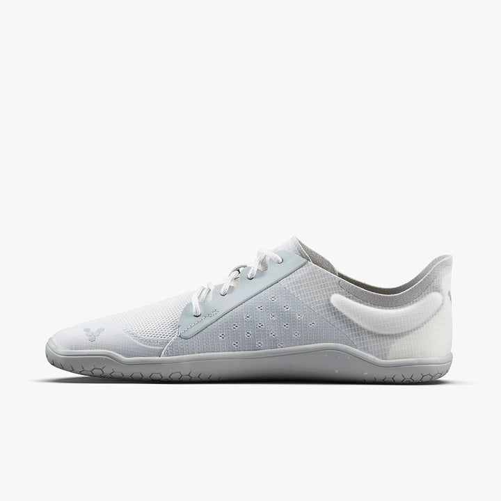The VIVOBAREFOOT Primus Lite IV (Men's) is a minimalist white and light gray trainer with a low profile, thin sole, mesh upper, and subtle side/heel branding, shown in a side view on a plain white background.
