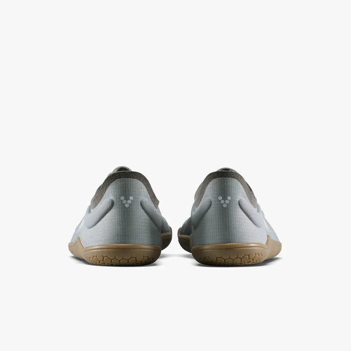 Rear view of two light grey Primus Lite IV (Women’s) minimalist barefoot training shoes by VIVOBAREFOOT with brown rubber soles.