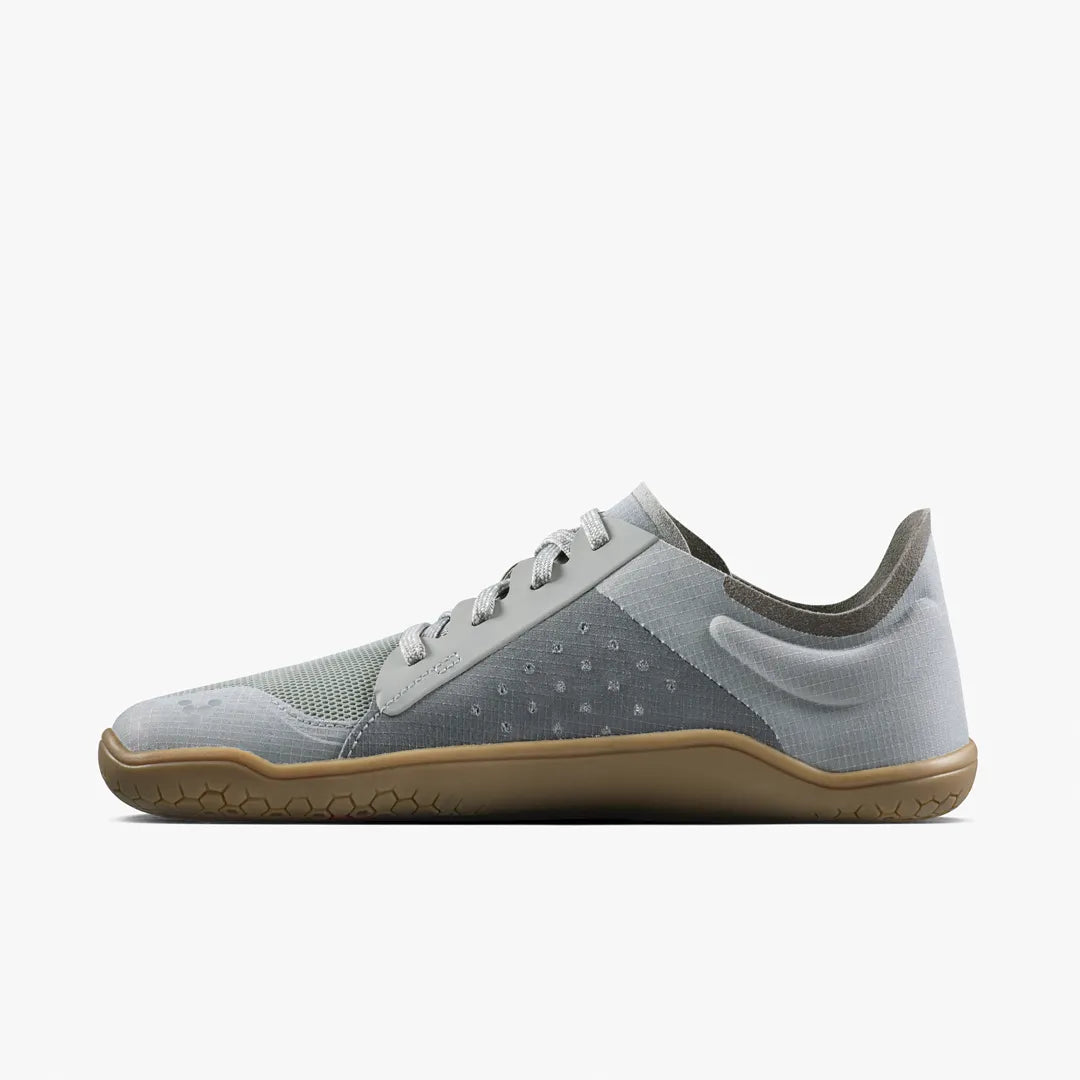 A grey Primus Lite IV (Women’s) low-top sneaker made from recycled materials, featuring a gum-colored flat sole.