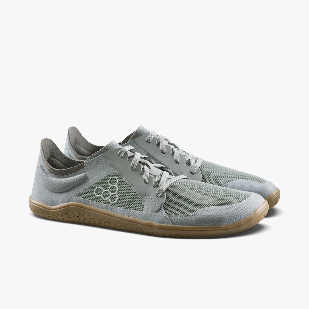 A pair of grey VIVOBAREFOOT Primus Lite IV (Men’s) vegan running shoes with gum-colored soles.
