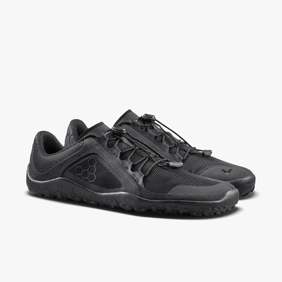 The VIVOBAREFOOT Primus Trail FG 3.5 (Men’s) all-terrain trainers feature breathable mesh uppers, textured soles, and quick-pull laces, showcased at an angle on a plain white background.