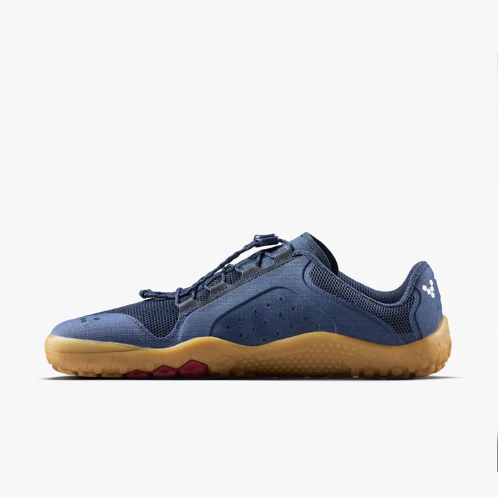 The VIVOBAREFOOT Primus Trail FG 3.5 (Men’s) is a blue minimalist athletic shoe featuring a tan sole, breathable mesh upper, and a white heel logo, displayed in side profile on a plain white background.
