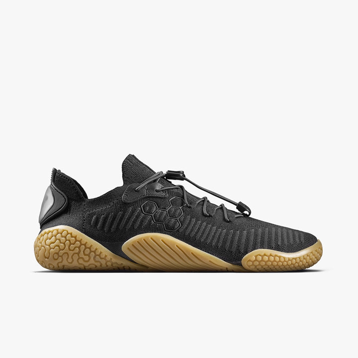 The Motus Flex Natural (Men's) by VIVOBAREFOOT is a black calisthenics shoe featuring a mesh upper, unique toggle lacing, hexagonal side patterns, and a natural rubber outsole for enhanced grip. Shown in side profile on a white background.