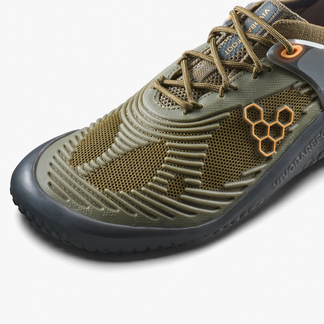 A close-up of VIVOBAREFOOT's Motus Strength II (Men's), an olive green and black minimalist barefoot trainer featuring a breathable mesh upper, hexagonal logo, and rugged rubber sole—perfect for high-impact workouts or CrossFit.