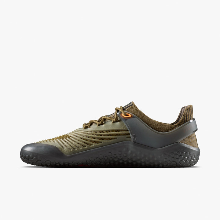 A side view of the VIVOBAREFOOT Motus Strength II (Men's) in olive green and brown features a textured sole, ribbed upper, mesh details, and orange lace eyelets—ideal for high-impact workouts—displayed on a plain white background.