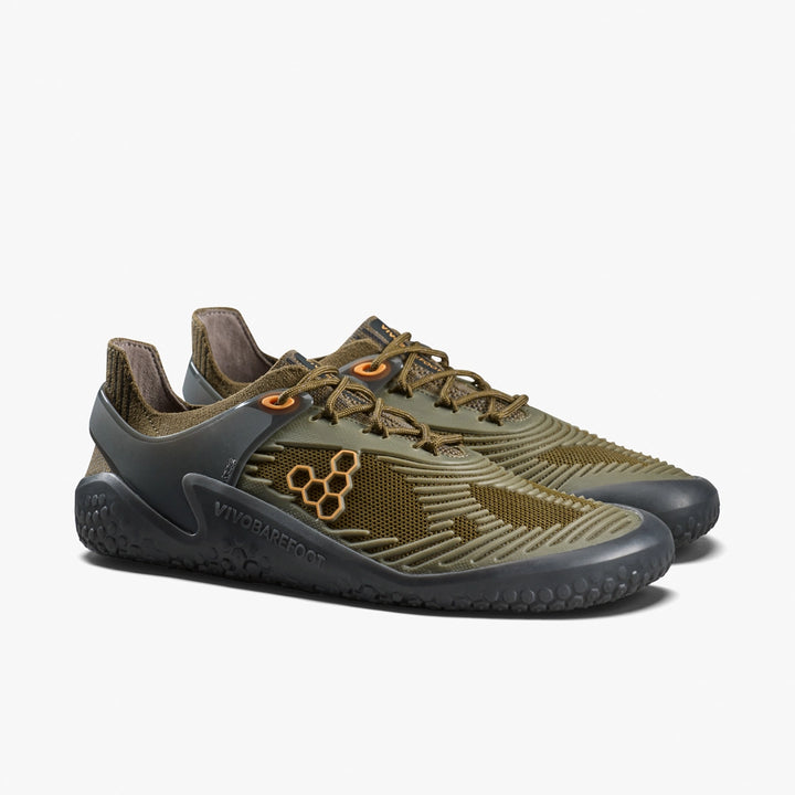 The Motus Strength II (Men's) by VIVOBAREFOOT—olive green barefoot trainer shoes with mesh panels, orange eyelets, black soles, and hexagonal logo accents—perfect for CrossFit or high-impact workouts, shown on a white background.