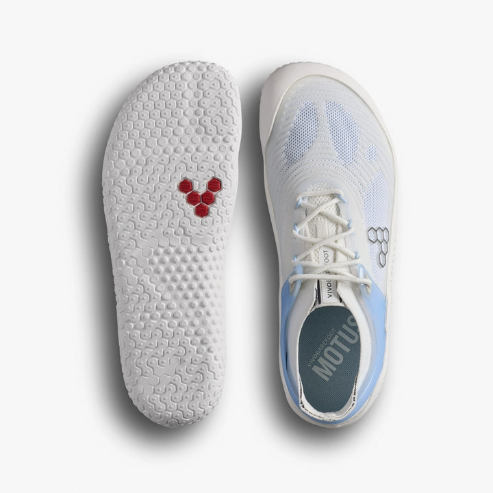 Top view of VIVOBAREFOOT Motus Strength II (Women's) in white with light blue accents—perfect for CrossFit or intense workouts. One shoe shows the textured sole and red hexagonal logo; the other displays laces, a mesh upper, and a small logo.