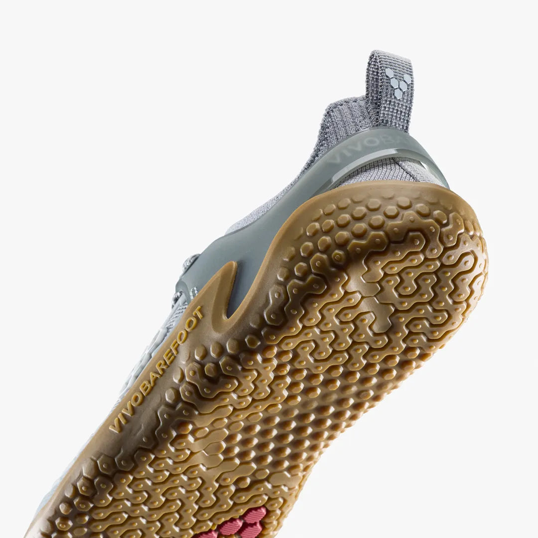 Close-up of the heel and textured rubber sole of a grey Motus Strength II (Men’s) by VIVOBAREFOOT.