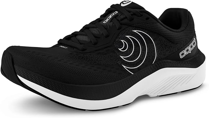 The TOPO Magnifly 6 (Women’s) running shoe—displayed from the front left angle in black with a white curved side design, white sole, and black laces—delivers the comfort and support of cushioned running shoes ideal for daily training.