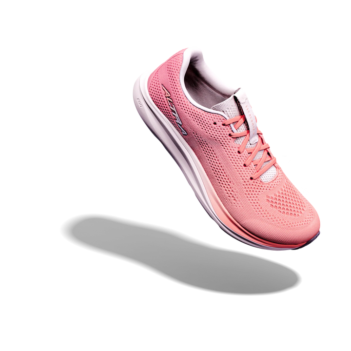 The ALTRA Escalante 5 (Women’s), a pink running shoe with a zero drop design and white sole, hovers in mid-air against a light gray background, casting a soft shadow below.