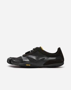 The Vibram KSO Evo (Men's) is a black minimalist athletic shoe featuring individual toe slots, a lace-up design, and a low-profile sole for enhanced ground feel, shown on a plain white background.