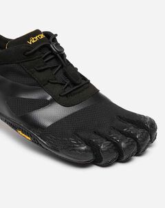 A close-up of the Vibram KSO Evo (Men's) showcases its black design with individual toe compartments, a textured sole for optimal ground feel, and an adjustable upper—ideal for barefoot-style running.