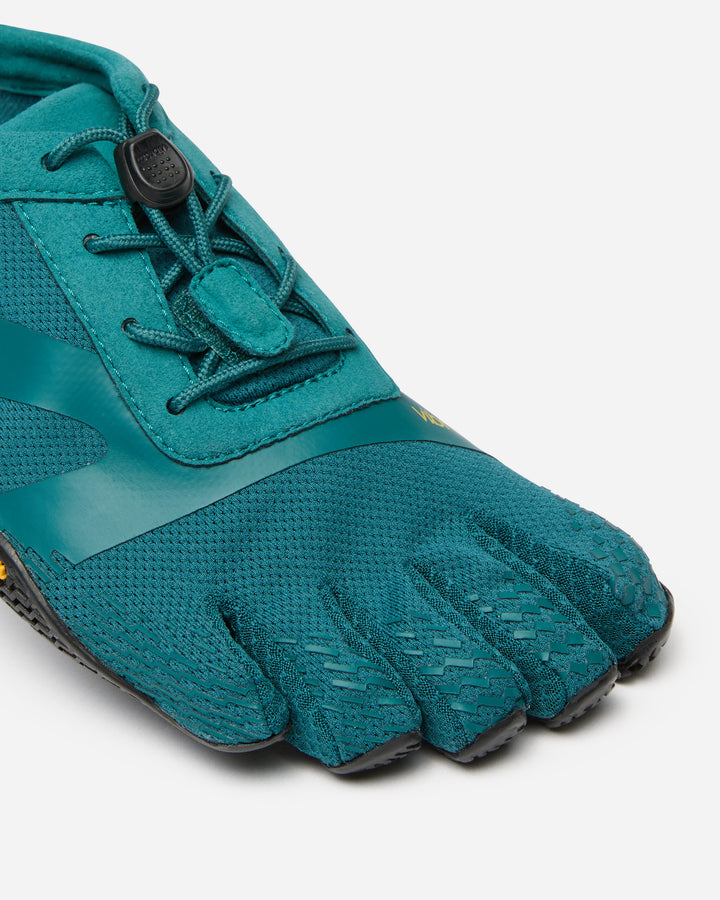 A close-up of the Vibram KSO Evo (Women's), a teal barefoot running shoe featuring individual toe sections, mesh upper, black sole, and elastic laces with toggle—perfect for functional fitness or balance training.