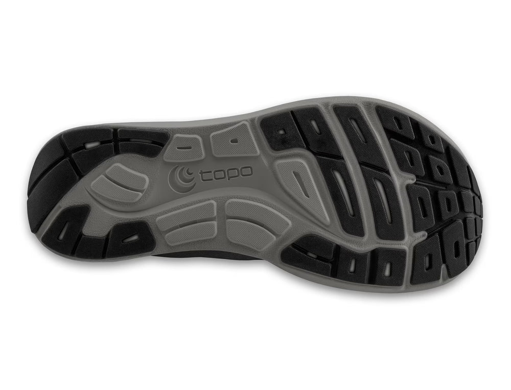 The image shows the outsole of the TOPO ST-6 (Men's) shoe, featuring a gray and black tread with textured grooves and the topo logo—highlighting its zero drop design for natural movement.