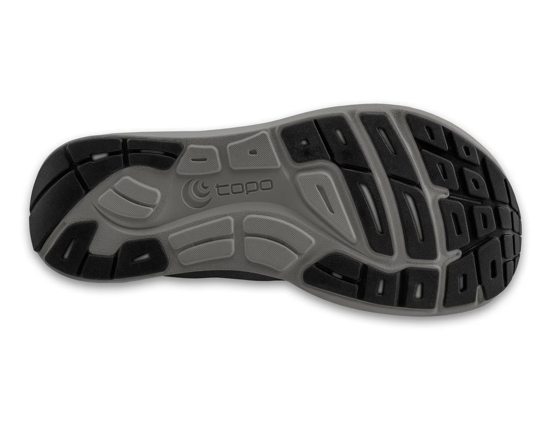 The image shows the outsole of the TOPO ST-6 (Men's) shoe, featuring a gray and black tread with textured grooves and the topo logo—highlighting its zero drop design for natural movement.