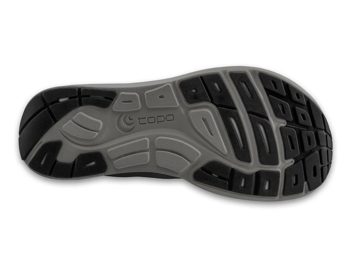 The image shows the outsole of the TOPO ST-6 (Men's) shoe, featuring a gray and black tread with textured grooves and the topo logo—highlighting its zero drop design for natural movement.