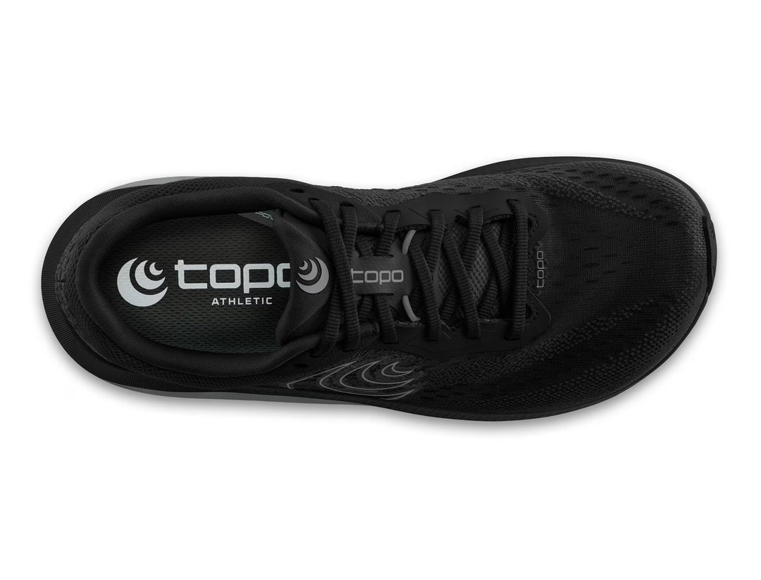 Top view of the TOPO Magnifly 6 (Men's) running shoe in black featuring black laces, visible TOPO logo on the insole, a breathable mesh upper, and a responsive ZipFoam midsole for comfort.