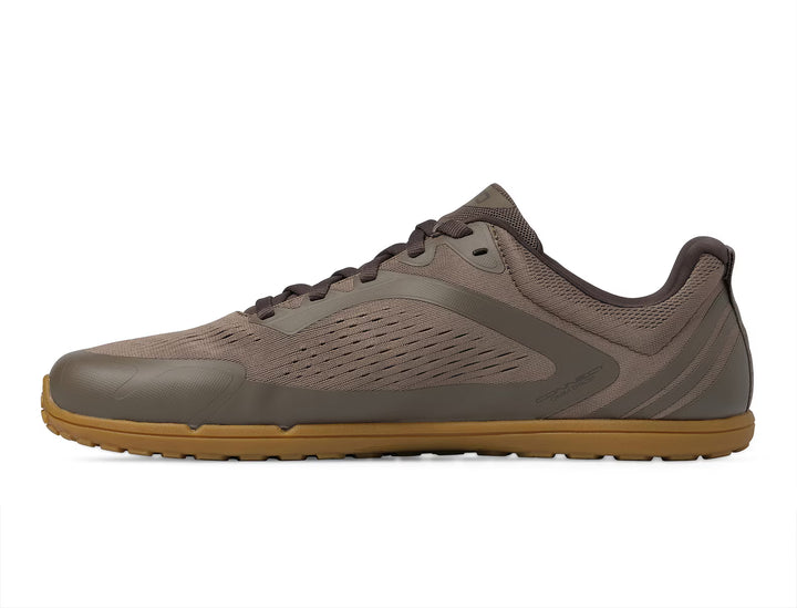 A side view of the TOPO Connect (Men’s) showcases its minimalist design, featuring a brown mesh upper, dark brown laces, and a light brown Vibram outsole, set against a white background.