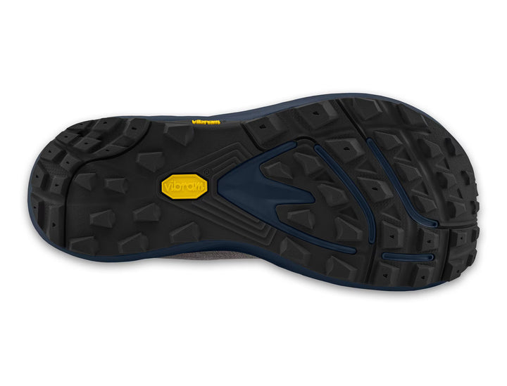 The TOPO Pursuit 3 (Men’s) features a black zero-drop design, with its outsole displaying a rugged Vibram Megagrip construction, deep lugs for superior traction, and a signature yellow Vibram logo at the center—all set on a cushioned platform engineered for optimal comfort and performance on the trail.