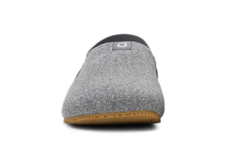 Front view of the Pagosa (Men's) gray wool slipper with a tan rubber sole and a small black logo patch on the upper, photographed against a white background.