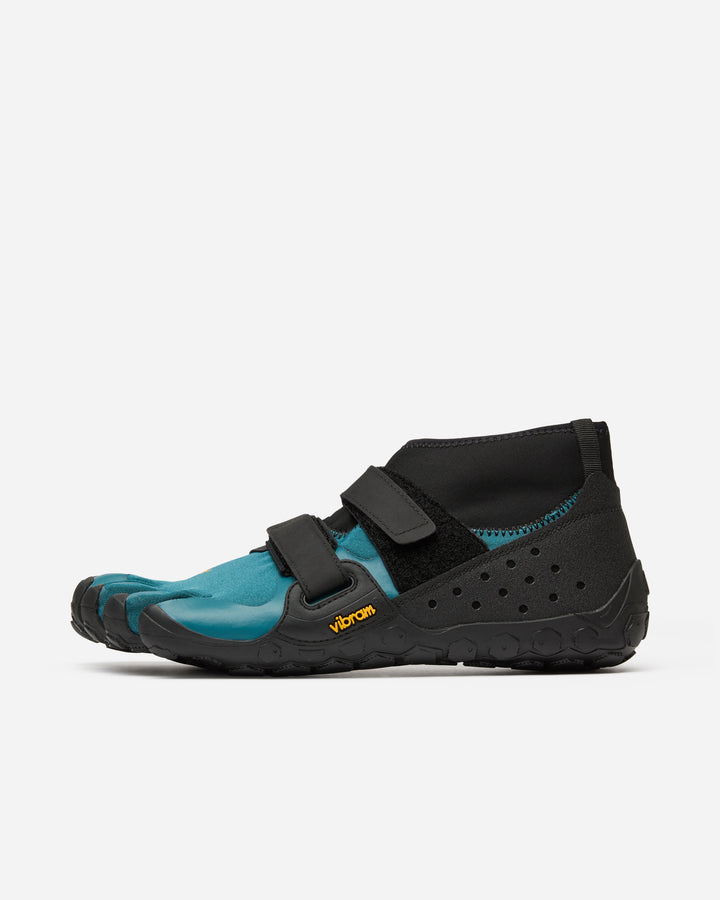 The Vibram Scramkey (Unisex) features a blue and black split-toe design, flexible black sole with yellow Vibram logo, Velcro straps, and ankle-height collar—perfect minimalist outdoor shoes for scrambling.