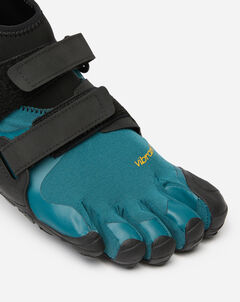 A close-up of the Vibram Scramkey (Unisex), a teal and black minimalist outdoor shoe with individual toe slots, Megagrip Elite sole, and two black Velcro straps across the top.
