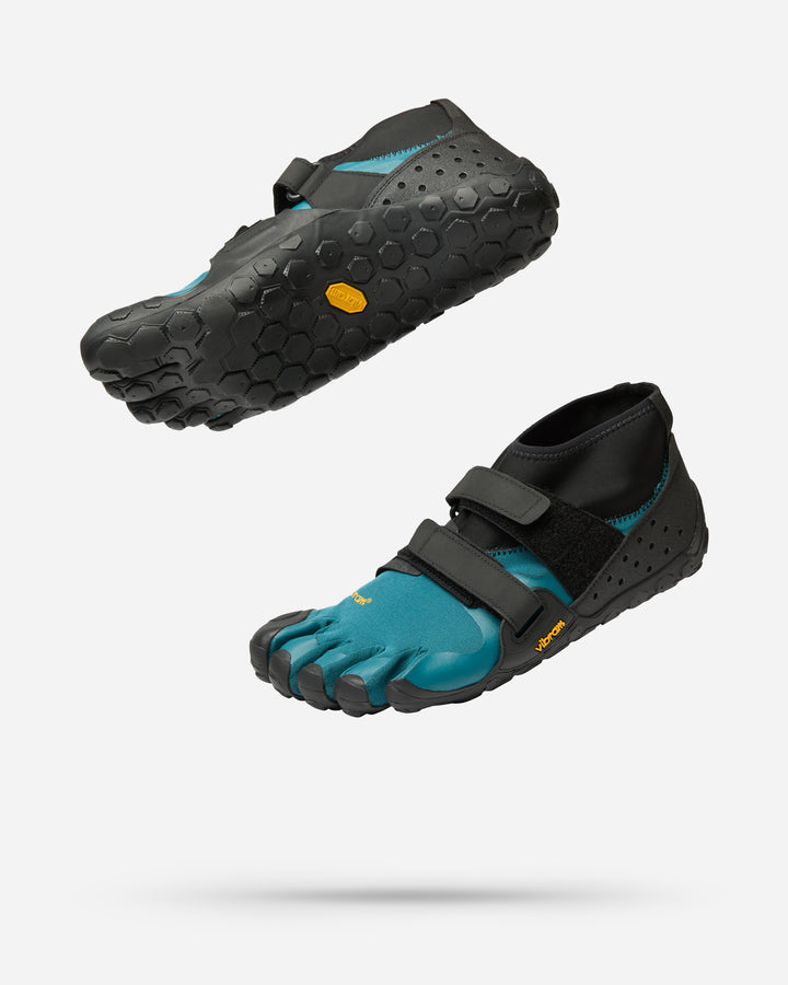 A pair of Vibram Scramkey (Unisex) blue and black minimalist outdoor shoes with individual toe pockets, Traction Lug technology, and textured rubber soles, displayed floating on a white background.