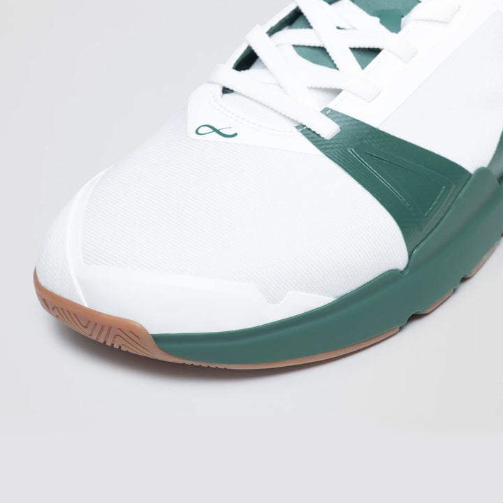 Close-up of the Notace KOTO 1 (Men's) gym shoe in white with green accents, white laces, and a gum sole. Features a stylized infinity logo near the toe and is designed for multidirectional court control.