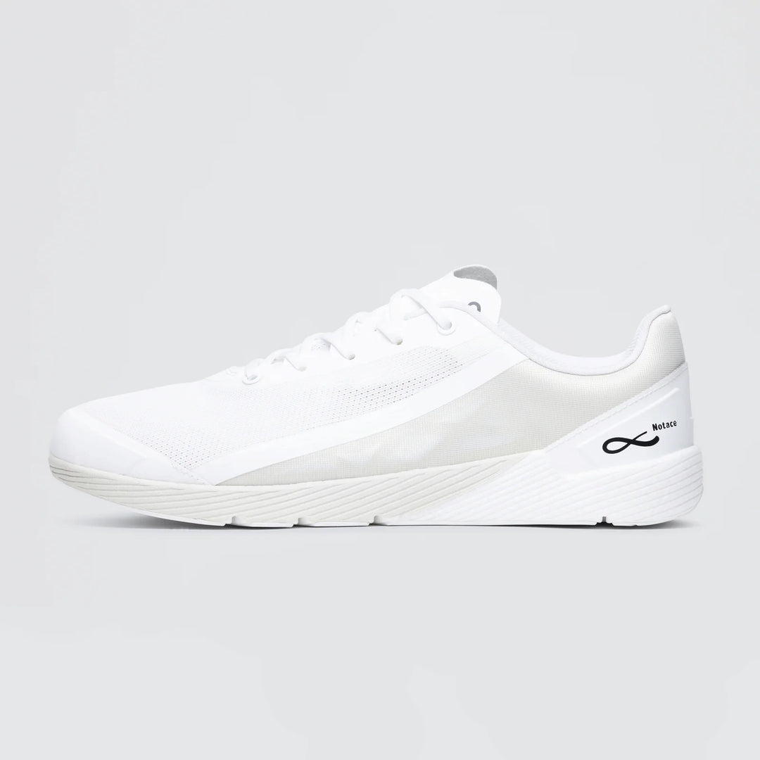 The Notace Michi 1 (Men’s) is a white athletic sneaker with a mesh upper, white laces, a subtle black logo by the heel, and an eTPU midsole for added comfort, shown on a plain light gray background.