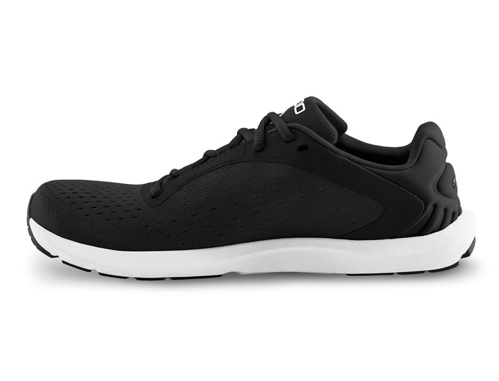 The TOPO ST-6 (Women's) is a black zero-drop athletic sneaker with a white sole, shown in side profile. It features a perforated upper, black laces, and a low-cut design ideal for barefoot running shoe enthusiasts.